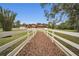White fence lines a path to the main house at 249 Dogwood Trce, Tarpon Springs, FL 34688