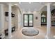 Elegant entryway with high ceilings, columns and a circular rug at 249 Dogwood Trce, Tarpon Springs, FL 34688