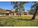 Two-story house with red tile roof and brick driveway at 249 Dogwood Trce, Tarpon Springs, FL 34688