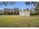 A metal garage with double doors is situated in a grassy area at 249 Dogwood Trce, Tarpon Springs, FL 34688