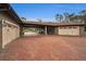 Attached garage with a covered brick patio area at 249 Dogwood Trce, Tarpon Springs, FL 34688