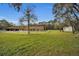 A large two-story house with a pool and detached garage sits on a spacious lot at 249 Dogwood Trce, Tarpon Springs, FL 34688