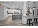 Open kitchen with gray island, stainless steel appliances, and white cabinets at 249 Dogwood Trce, Tarpon Springs, FL 34688