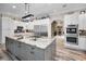 Gourmet kitchen with large island, stainless steel appliances, and gray cabinets at 249 Dogwood Trce, Tarpon Springs, FL 34688