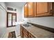 Bright laundry room with washer, dryer, sink, and ample cabinetry at 249 Dogwood Trce, Tarpon Springs, FL 34688