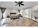 Bright main bedroom featuring a king-size bed, sitting area, and ensuite access at 249 Dogwood Trce, Tarpon Springs, FL 34688