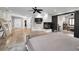 Luxurious main bedroom with a barn door, fireplace, and sitting area at 249 Dogwood Trce, Tarpon Springs, FL 34688