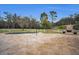 Pool and spa with travertine decking and a large backyard at 249 Dogwood Trce, Tarpon Springs, FL 34688