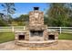 Freestanding stone fireplace with double-sided fireboxes at 249 Dogwood Trce, Tarpon Springs, FL 34688