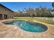 Freeform swimming pool and spa with travertine decking at 249 Dogwood Trce, Tarpon Springs, FL 34688
