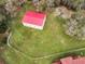 Detached workshop with red roof, offering ample workspace at 249 Dogwood Trce, Tarpon Springs, FL 34688