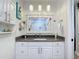 Bathroom with white vanity and dark countertop at 322 Boca Ciega Point N Blvd, St Petersburg, FL 33708