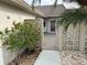 Courtyard entry with gate and tropical landscaping at 322 Boca Ciega Point N Blvd, St Petersburg, FL 33708