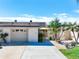 Tan two-car garage with palm trees and courtyard entry at 322 Boca Ciega Point N Blvd, St Petersburg, FL 33708
