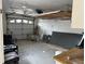 Unfinished garage with overhead storage and tools at 322 Boca Ciega Point N Blvd, St Petersburg, FL 33708