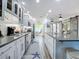 Modern kitchen with island, white cabinets, and open layout at 322 Boca Ciega Point N Blvd, St Petersburg, FL 33708