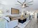 Open living room with sectional sofa and kitchen view at 322 Boca Ciega Point N Blvd, St Petersburg, FL 33708