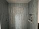Shower with blue-gray tile and pebble accents at 322 Boca Ciega Point N Blvd, St Petersburg, FL 33708