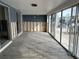 Under-renovation sunroom featuring tile floors and sliding glass doors at 322 Boca Ciega Point N Blvd, St Petersburg, FL 33708