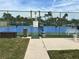 Community tennis courts with blue surface and surrounding fence at 322 Boca Ciega Point N Blvd, St Petersburg, FL 33708