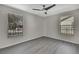 Well-lit bedroom with grey walls and laminate flooring at 3332 Vorden St, New Port Richey, FL 34655