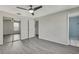 Bright bedroom with mirrored closet doors and ceiling fan at 3332 Vorden St, New Port Richey, FL 34655
