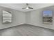 Spacious bedroom with grey laminate flooring and ceiling fan at 3332 Vorden St, New Port Richey, FL 34655