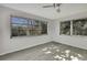 Bright living room with large windows and wood-look floors at 3332 Vorden St, New Port Richey, FL 34655