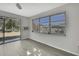 Living room with large windows, sliding glass doors, and pond view at 3332 Vorden St, New Port Richey, FL 34655