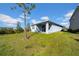 House back view, showcasing a patio and green lawn at 34104 White Fountain Ct, Wesley Chapel, FL 33545