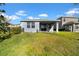 House back view, showcasing a patio and green lawn at 34104 White Fountain Ct, Wesley Chapel, FL 33545