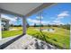 Covered patio overlooking a pond and grassy backyard at 34104 White Fountain Ct, Wesley Chapel, FL 33545