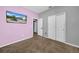 Bedroom with a neutral color scheme, carpet floors, and double door closet at 34104 White Fountain Ct, Wesley Chapel, FL 33545