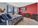 Main bedroom with a king-size bed, and a red accent wall at 34104 White Fountain Ct, Wesley Chapel, FL 33545