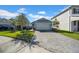 Two-story house with gray exterior and a paved driveway at 34104 White Fountain Ct, Wesley Chapel, FL 33545