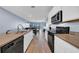 Modern kitchen with long countertop, stainless steel appliances, and tile floors at 34104 White Fountain Ct, Wesley Chapel, FL 33545