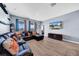 Living room with sectional sofa, large TV, and access to backyard at 34104 White Fountain Ct, Wesley Chapel, FL 33545