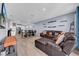 Spacious living room featuring a large sectional sofa and tile floors at 34104 White Fountain Ct, Wesley Chapel, FL 33545
