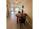 Dining area with wood table and chairs, and a view into living room at 3425 96Th N Ter # 4, Pinellas Park, FL 33782