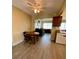 Dining area with wood table and chairs, and a view into living room at 3425 96Th N Ter # 4, Pinellas Park, FL 33782