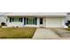 White single story home with blue shutters, attached garage, and small front yard at 3425 96Th N Ter # 4, Pinellas Park, FL 33782