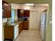 Galley style kitchen with wood cabinets and granite countertops at 3425 96Th N Ter # 4, Pinellas Park, FL 33782