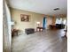 Living room with gray vinyl flooring, and a view into dining area at 3425 96Th N Ter # 4, Pinellas Park, FL 33782