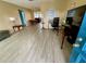 Living room with light gray vinyl flooring, and a view into dining area at 3425 96Th N Ter # 4, Pinellas Park, FL 33782