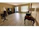 Living room with light gray vinyl flooring, and a view into dining area at 3425 96Th N Ter # 4, Pinellas Park, FL 33782
