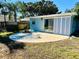 Large backyard with circular patio and sliding glass doors at 3528 Linkwood St, New Port Richey, FL 34652