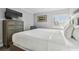 Spacious bedroom with large bed, dresser, and window at 36750 Us Highway 19 N # 13301, Palm Harbor, FL 34684