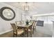 Elegant dining room features a glass-top table and views into the living room at 36750 Us Highway 19 N # 13301, Palm Harbor, FL 34684