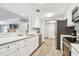 Modern kitchen with stainless steel appliances and white cabinetry at 36750 Us Highway 19 N # 13301, Palm Harbor, FL 34684