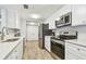 Updated kitchen with stainless steel appliances and white cabinets at 36750 Us Highway 19 N # 13301, Palm Harbor, FL 34684